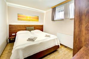 Postel nebo postele na pokoji v ubytování Appartement Alpensee