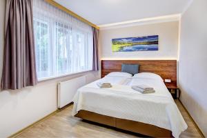 Postel nebo postele na pokoji v ubytování Appartement Alpensee