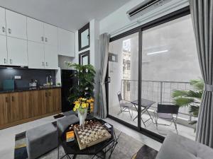 a living room with a table and a kitchen at Cygnus Homestay Ha Noi 89 in Hanoi +17 photos