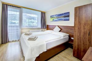 Postel nebo postele na pokoji v ubytování Appartement Alpensee
