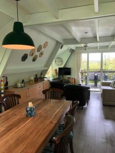 a living room with a wooden table and a couch at Durbuy chalet 65 in Durbuy