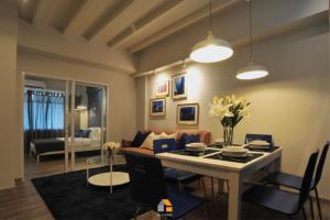 a living room with a table and a couch at Baan Sri-kram 550m from MRT Taopoon in Bang Su +9 photos