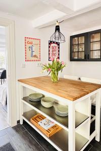a kitchen island with a table and plates at Das Stader Schwedenhaus mit Garten in Stade +18 photos