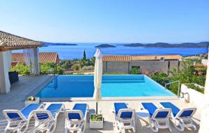 a villa with a swimming pool and chairs at Villa Blue by Villas Guide in Dubrovnik