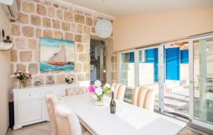 a dining room with a white table and chairs at Villa Blue by Villas Guide in Dubrovnik