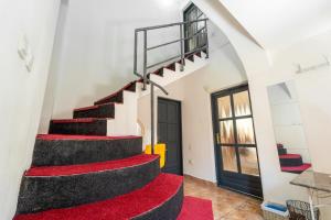 a staircase in a house with a red carpet at Private villa in the historic center in Cluj-Napoca