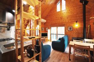 a kitchen and living room in a log cabin at The Creek Cottage in Habu