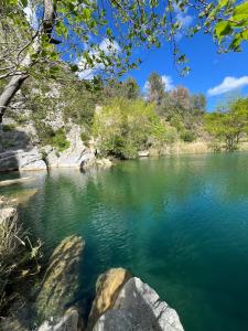 a view of a river with green water and trees at Élégant studio avec jacuzzi in Saint-Paul-de-Fenouillet