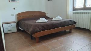 a bedroom with a bed with two towels on it at Ca' tommy in Ceppo Morelli