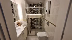 a bathroom with a shower and a toilet and a sink at Elite Luxury Suite - Elize 4 in Alanya +18 photos