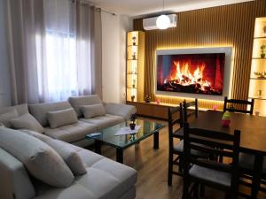 a living room with a couch and a fireplace at VILA Moreja in Berat