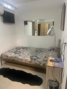 a bedroom with a bed and a desk with a mirror at Centrally Located Private Rooms in Heraklio Town