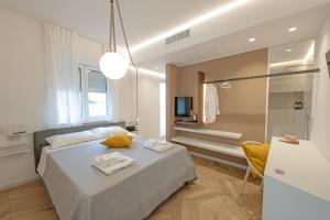a bedroom with a bed and a bathroom at Elisea Your City Escape in Polignano a Mare