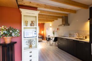 a kitchen and dining room with wooden ceilings at Het Dijkje Utrecht in Utrecht