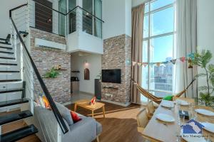 a living room with a couch and a table at Maritime in George Town