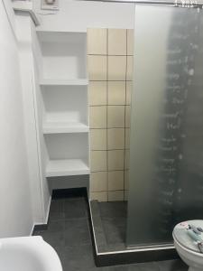 a bathroom with a shower and a toilet at Centrally Located Private Rooms in Heraklio Town