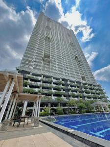 a tall building with a swimming pool in front of it at The Intramuros Family Suite in Manila