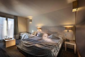 A bed or beds in a room at Brenta Dolomites