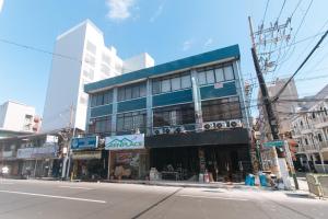 a building on the corner of a city street at GREN PLACE near Baclaran Airport Road by RedDoorz in Manila
