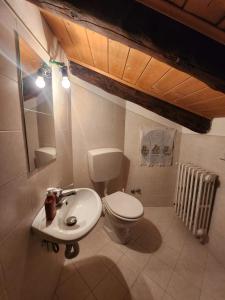 a bathroom with a toilet and a sink at Casa montagna relax in Cedegolo