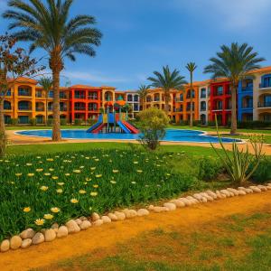 a resort with a swimming pool and a playground at Porto matrouh Blue sea in Marsa Matruh