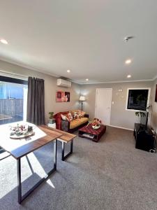 a living room with a couch and a table at The heart of Palmerston North in Palmerston North