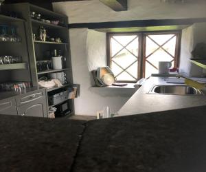 a kitchen with a sink and a window at Lilla Baren i Träkumla in Visby