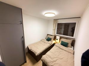 a small room with two beds and a window at Relax Garden Igal in Igal
