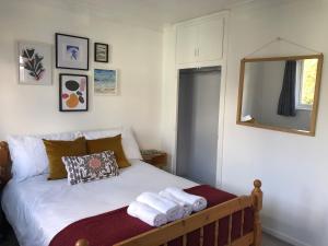a bedroom with a bed with towels on it at Stylish Room Close to Beaches in Falmouth