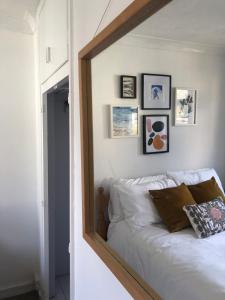 a mirror reflection of a bed in a bedroom at Stylish Room Close to Beaches in Falmouth