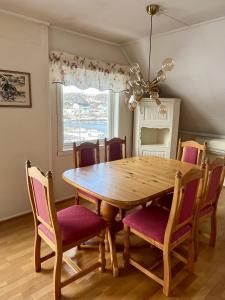 a dining room with a wooden table and chairs at Budget apartment in Gravdal in Gravdal