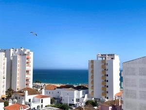 a view of a city with buildings and the ocean at T1 na 1 linha da Praia da Rocha in Portimão