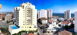an aerial view of a city with tall buildings at T1 na 1 linha da Praia da Rocha in Portimão