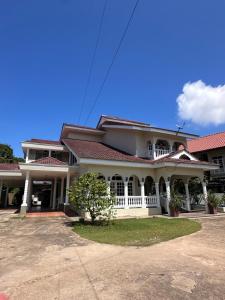 a large white house with a red roof at The Nook, Kuala Terengganu in Kuala Terengganu