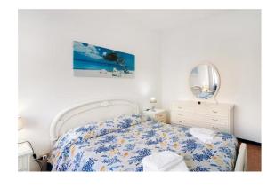 a bedroom with a bed and a mirror and a dresser at Casa del pescatore in Alassio