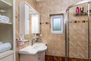 a bathroom with a sink and a shower at Katerina's garden Apartment 2 - Tertsa Ierapetra in Térsa