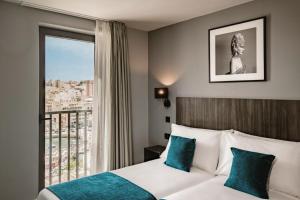 Postel nebo postele na pokoji v ubytování Spinola Hotel
