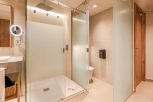 a glass shower in a bathroom with a toilet at BANCAL HOTEL and SPA in San Sebastián de la Gomera +48 photos