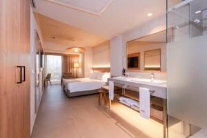 a hotel room with a bed and a bathroom at BANCAL HOTEL and SPA in San Sebastián de la Gomera