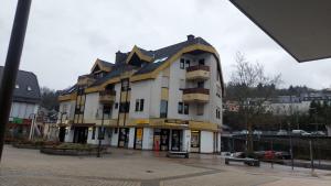 a large white building with a black roof at Bahnhofsnest in Idar-Oberstein