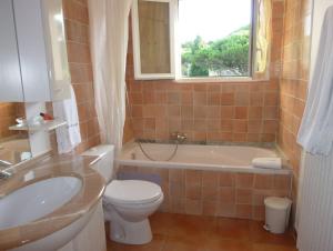 a bathroom with a toilet and a sink and a tub at Hotel Martinengo in Sainte-Maxime +36 photos