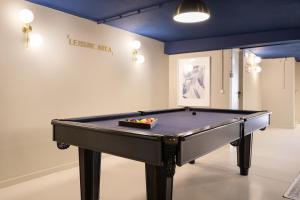 a pool table in a room with a wall at Lapa Diplomatic Suites & Flats by Feel Lisboa in Lisbon +31 photos