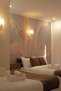 a hotel room with two beds and a wall mural at Belladama Hotel in San Carlos +57 photos