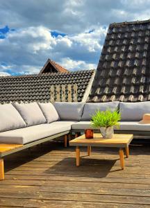 a couch sitting on top of a wooden deck at Die Art Farm I Group Rental near Frankfurt I Messe in Schoneck
