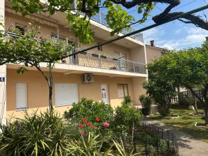 a building with a balcony and flowers in front of it at Prestige in Podgorica