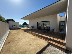 a house with a deck with chairs on it at Villa Noam Haut Standing 220m2 in Beauvoisin