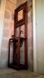 a wooden door with a mirror on a brick wall at Residence with a view of the historic center in Polignano a Mare
