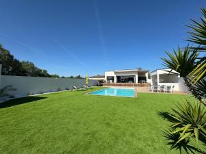 a yard with a swimming pool and a house at Villa Noam Haut Standing 220m2 in Beauvoisin