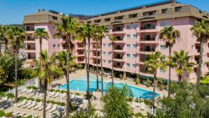 an aerial view of a hotel with a pool and palm trees at AQUA Hotel The Breeze & Spa - All Inclusive - Adults Only - 4Sup in Santa Susanna