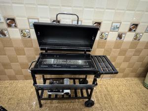 a serving cart in a room with a wall at Ớt Family - 128 Cái Bèo - Homestay Cat Ba in Cat Ba